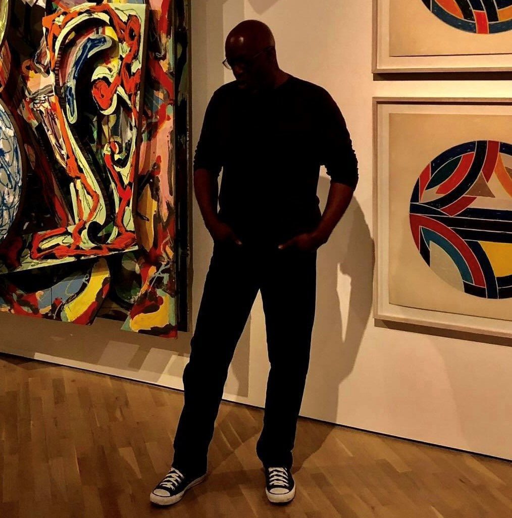 ChrisBellfull-body-silhouette-standing-before-an-art-display